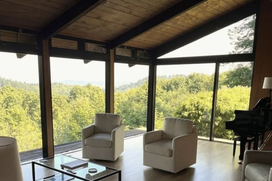 Living room renovation with wood beams, and large windows in a southwest hills Portland home.